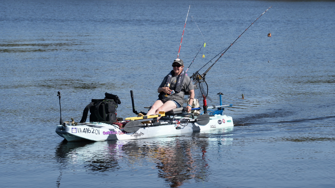 a woman on a blue kayak with bixpy motor adapter steering system