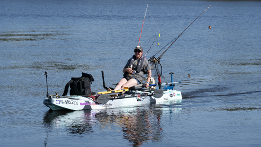 a woman on a blue kayak with bixpy motor adapter steering system