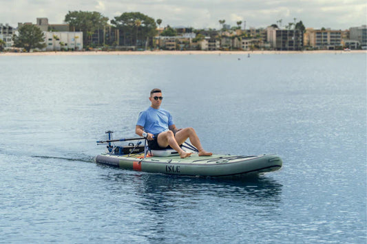 Man motors on open water in an ISLE paddle board with a Bixpy Canada K-1 Motor