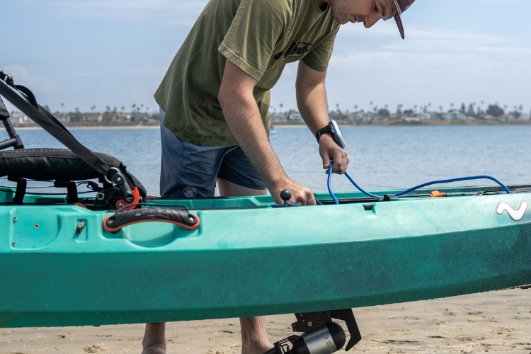 Man examines Bixpy motor connections to check they are good to go on personal watercraft
