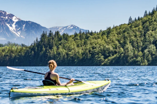 Woman paddling in Canada with K-1 attached to kayak