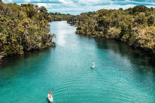 Two people use SUPs with the Bixpy Canada K1 to explore hidden channels