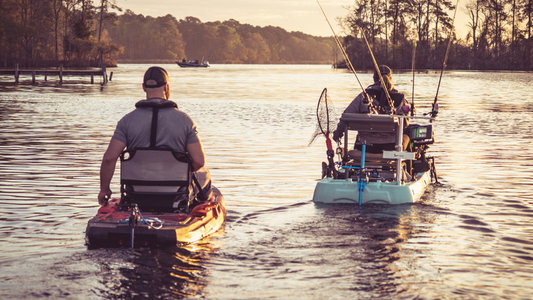 two men on kayaks on a lake