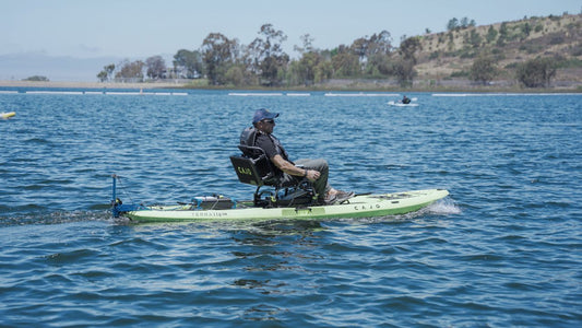 man kayaking on lake with bixpy motor system attached
