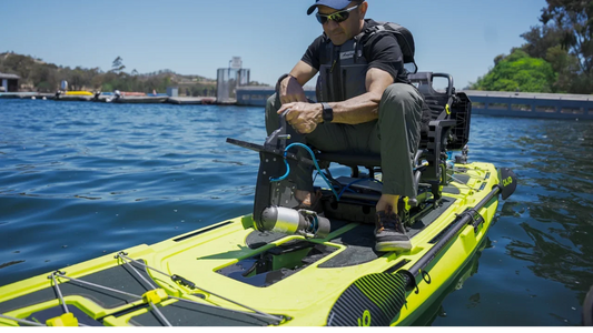 a man putting in pedal drive adapter with bixpy Canada motor onto a kayak