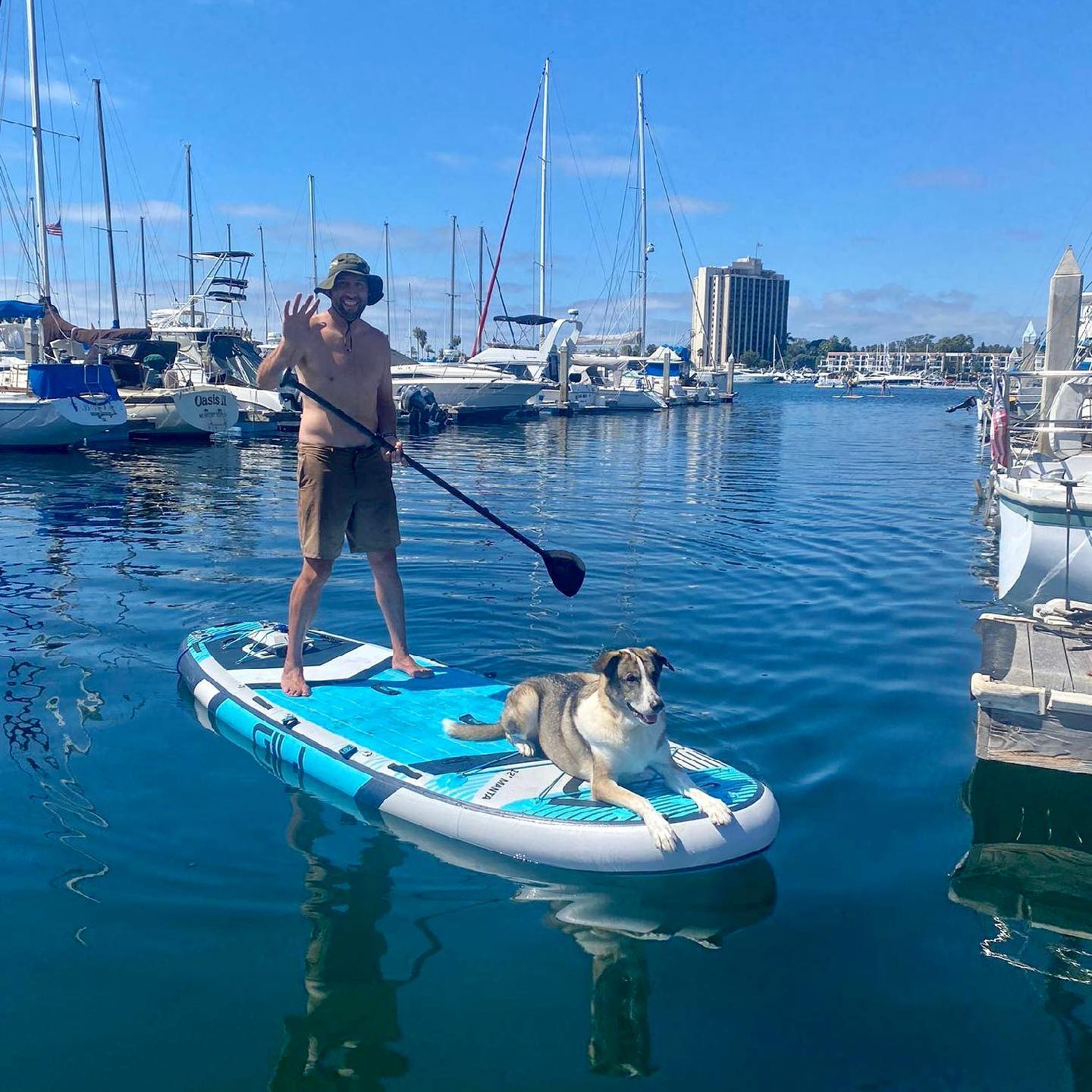 man paddleboarding with dog using a Bixpy motor
