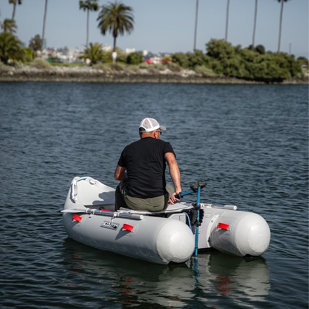 Man sits in inflatable boat powered by Bixpy Motor