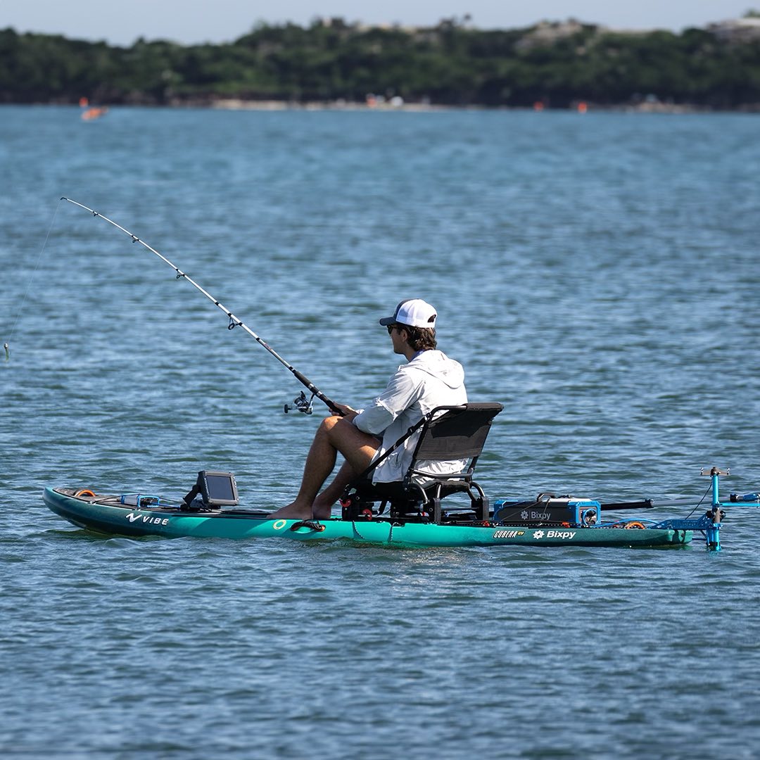 Man sitting in kayak fishing with K-1 Motor using the K-1 Motor Bumper