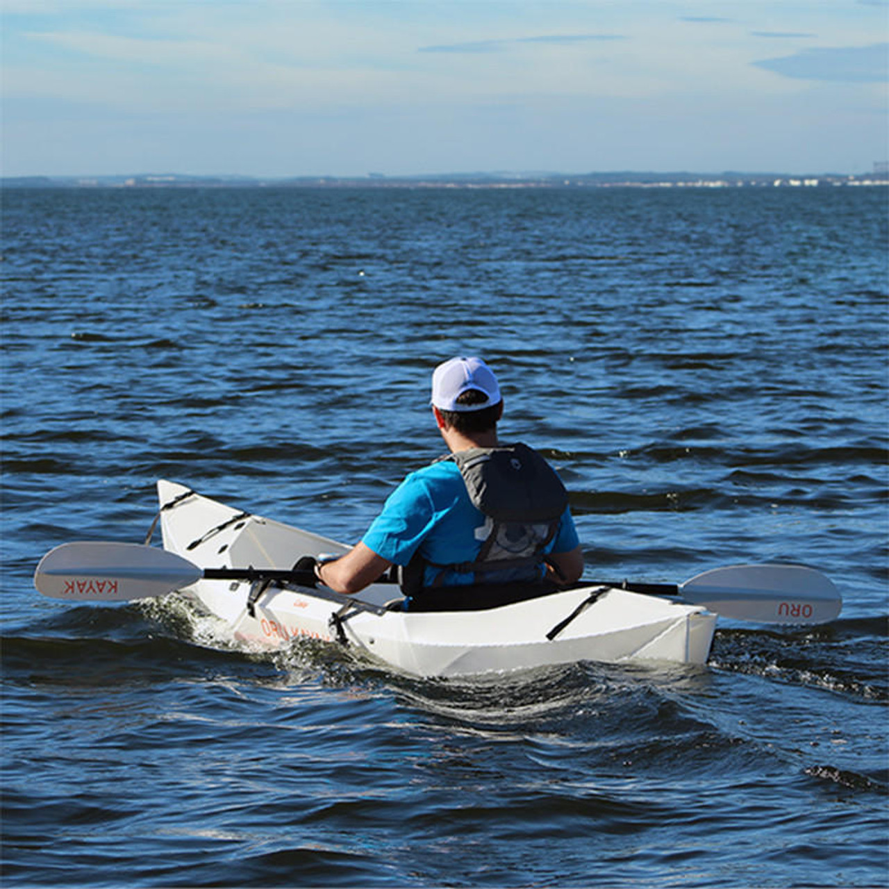 Man paddling in Oru kayak using Oru Adapter with Bixpy Motor